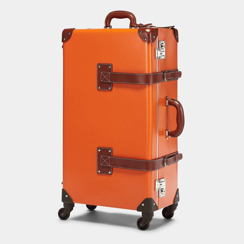 Angled product view of the check-in spinner Anthropologist leather suitcase in orange