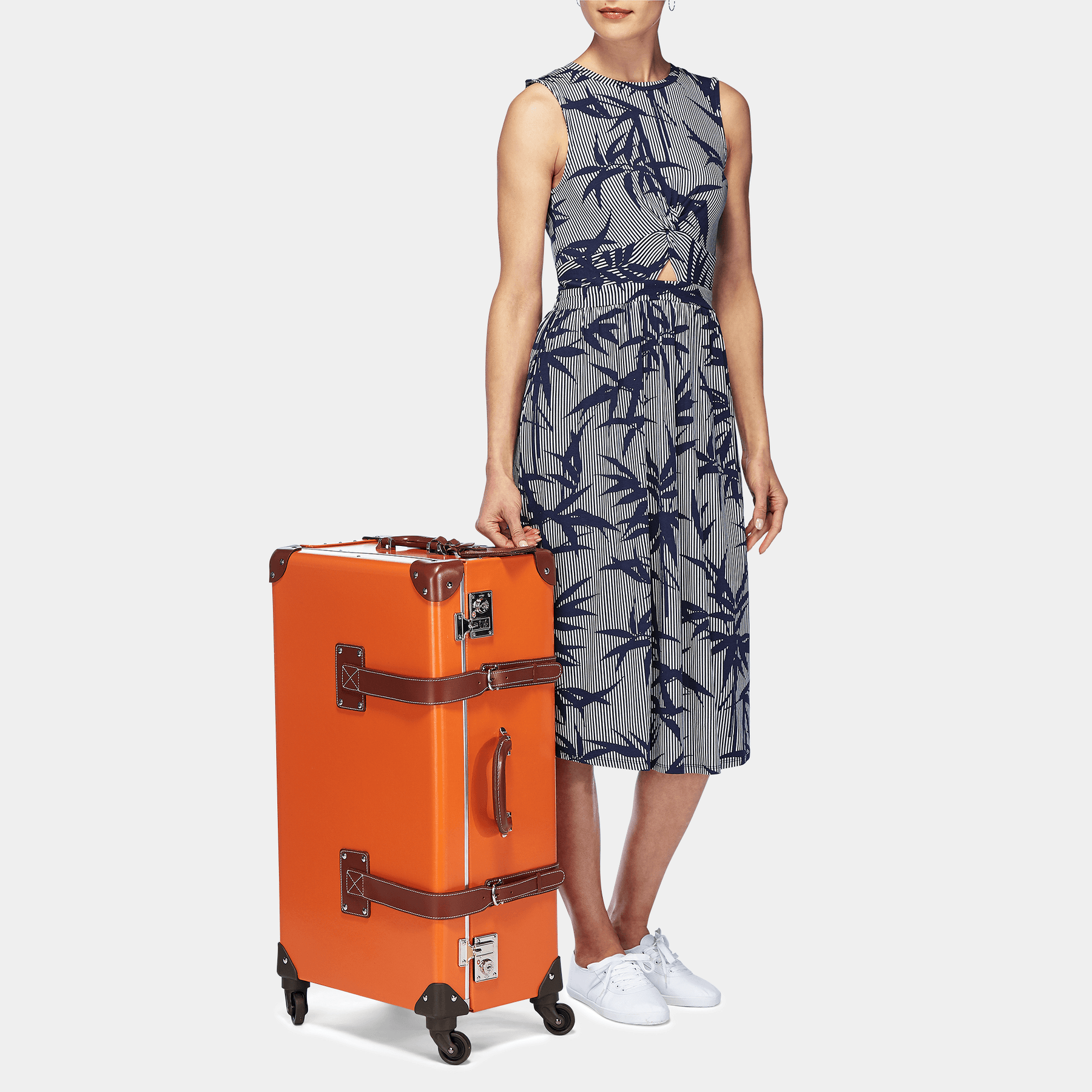 Model with the check-in Anthropologist leather suitcase in orange