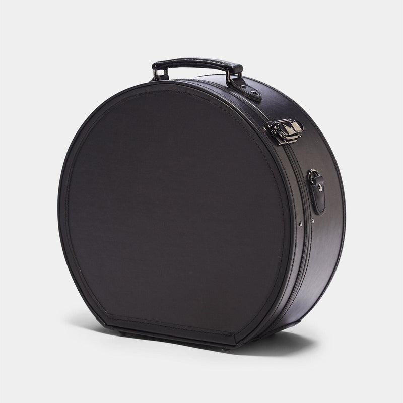 Angled product view of the large hatbox Industrialist fibreboard suitcase in  black