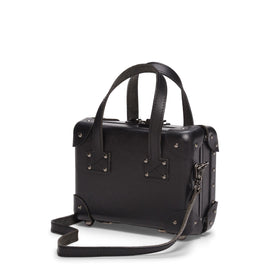 Angled product view of the mini Industrialist fibreboard suitcase in black with shoulder attachment strap
