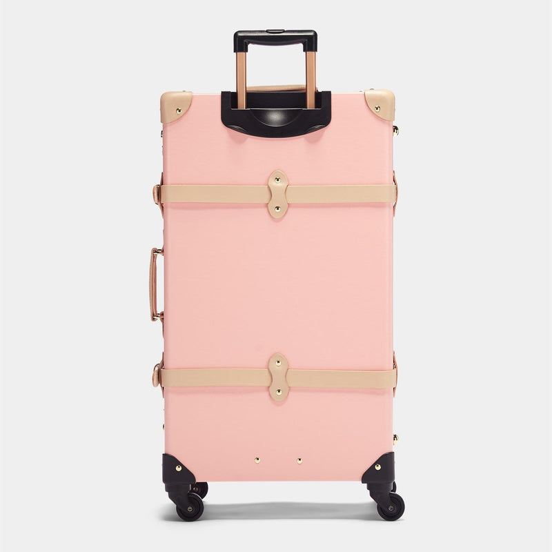 Back product view of the check-in Correspondent fibreboard suitcase in pink with raised handle
