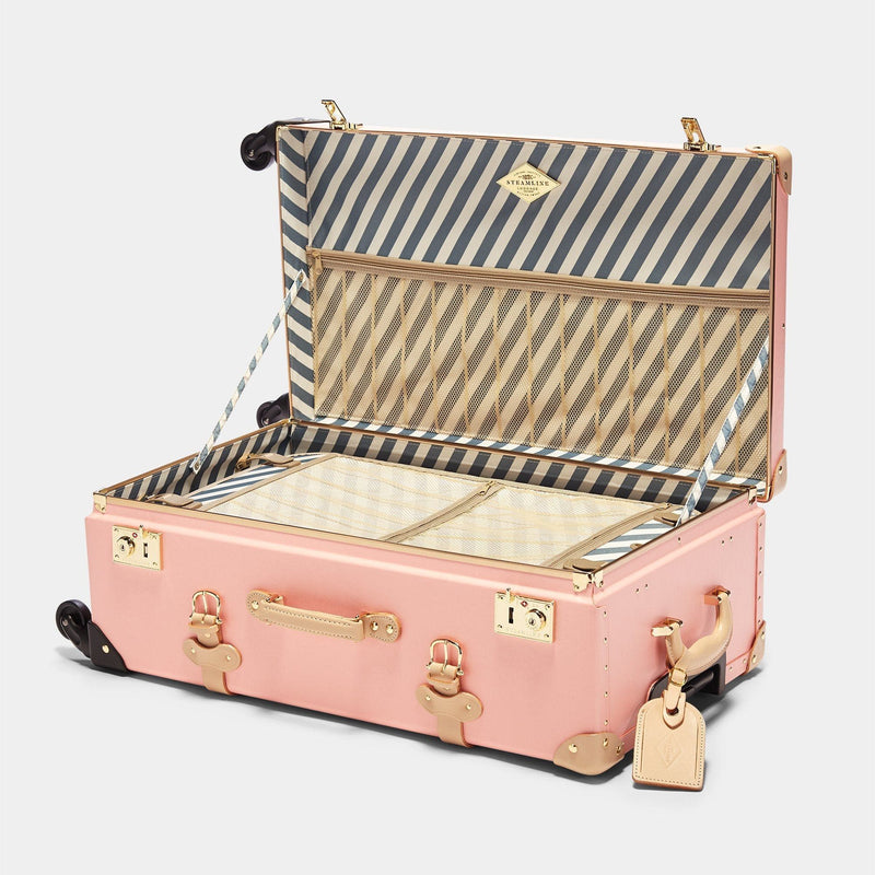 Open product view of the check-in Correspondent fibreboard suitcase in pink with blue and white stripe print lining