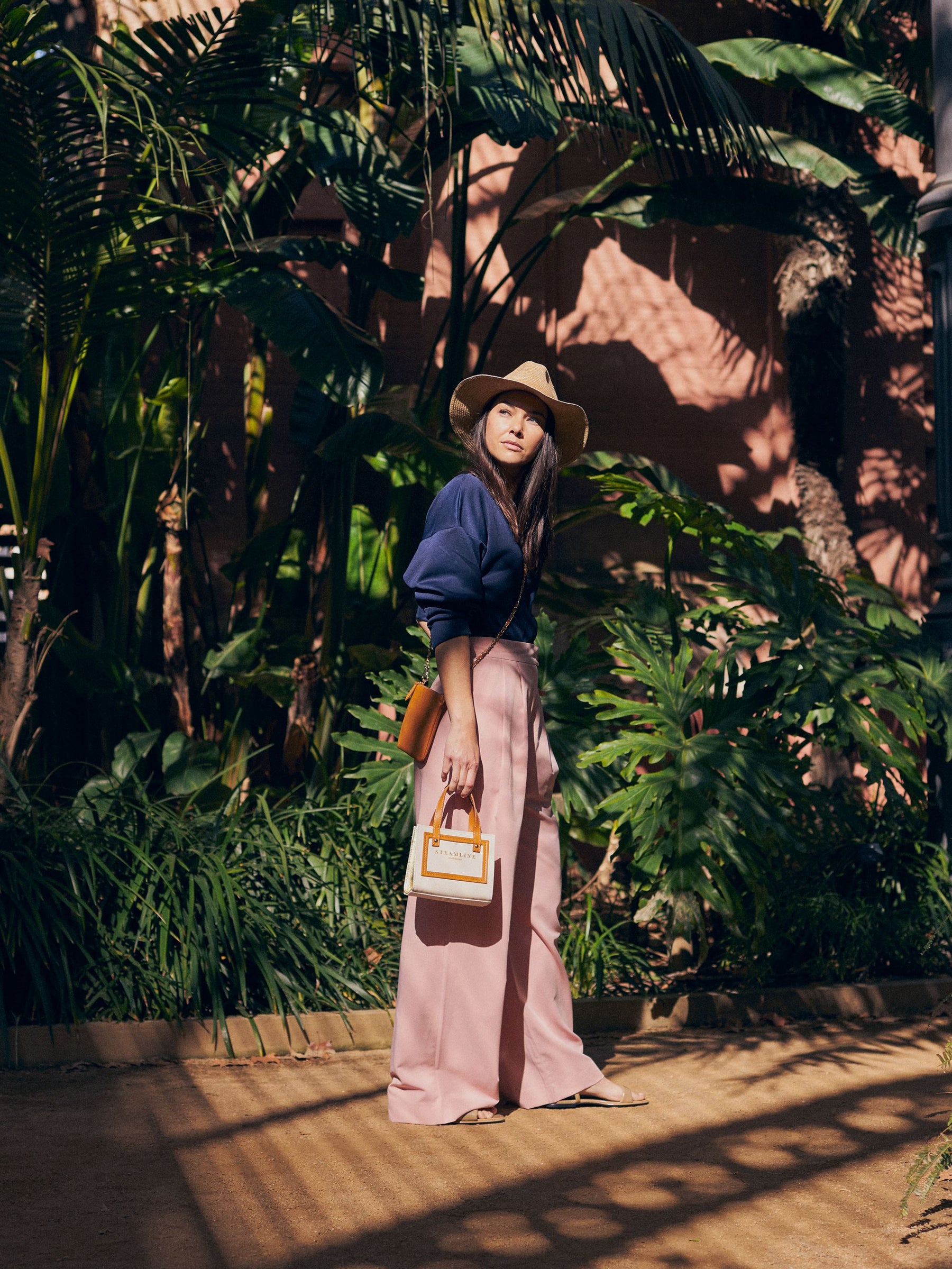 Lifestyle image of model with the Navigator handbags in nut brown