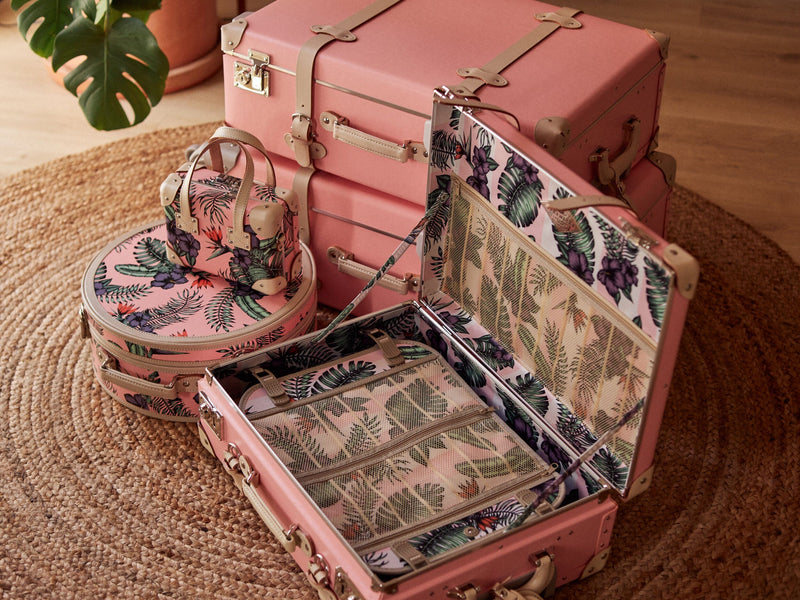 Lifestyle image of Steamline retro luggage set of Botanist fibreboard suitcases in pink