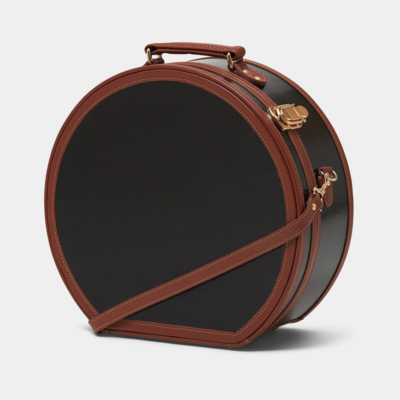 Angled product view of the deluxe hatbox Diplomat leather suitcase in black with shoulder attachment strap