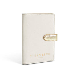 Angled view of the Navigator leather passport holder in white with gold trim and logo