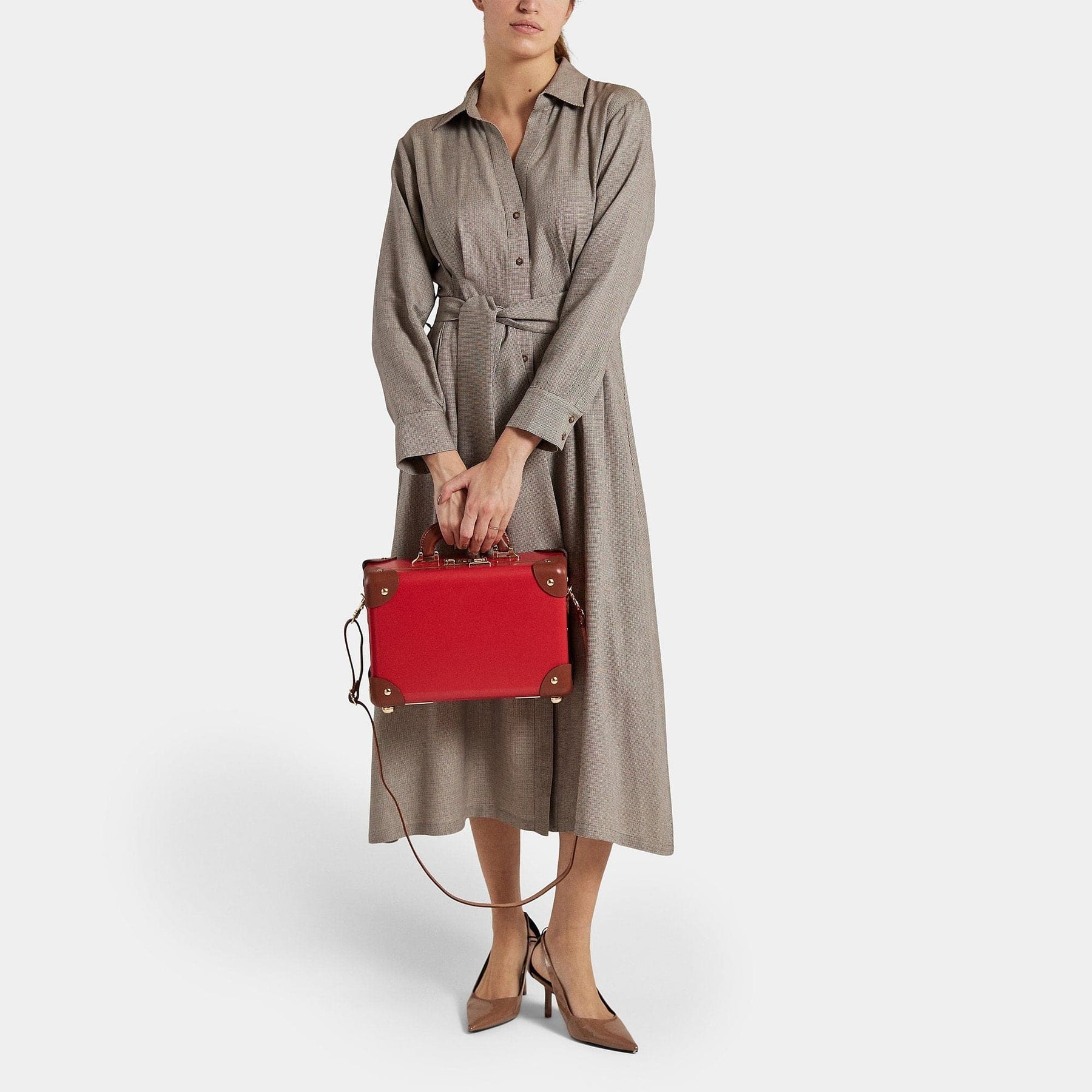 Model with the vanity Diplomat leather suitcase in red with shoulder attachment strap