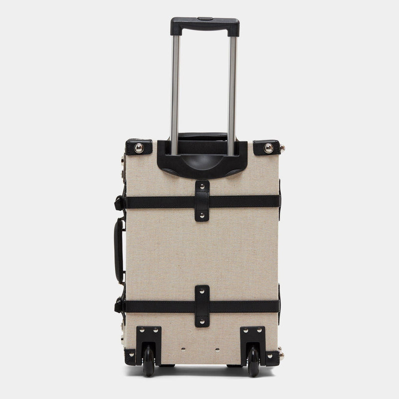 Back product view of the carry-on Editor linen suitcase with black trims and raised handle