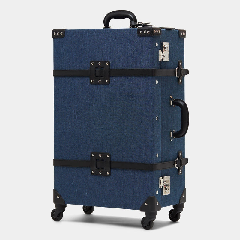 Angled product view of the check-in spinner Editor linen suitcase with navy body and black trims