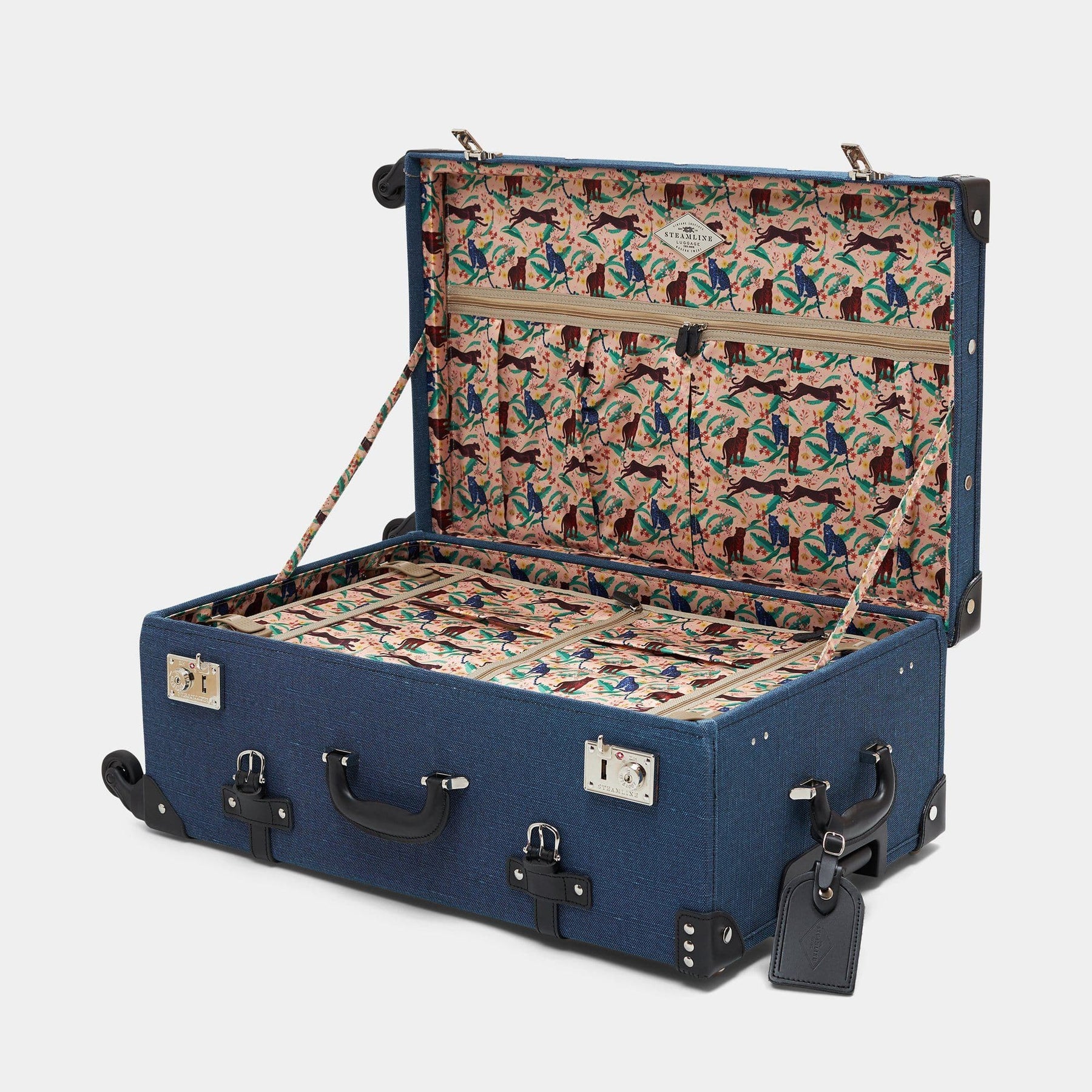 Open product view of the check-in spinner Editor linen suitcase with navy body and black trims, cheetah print lining and black leather luggage tag