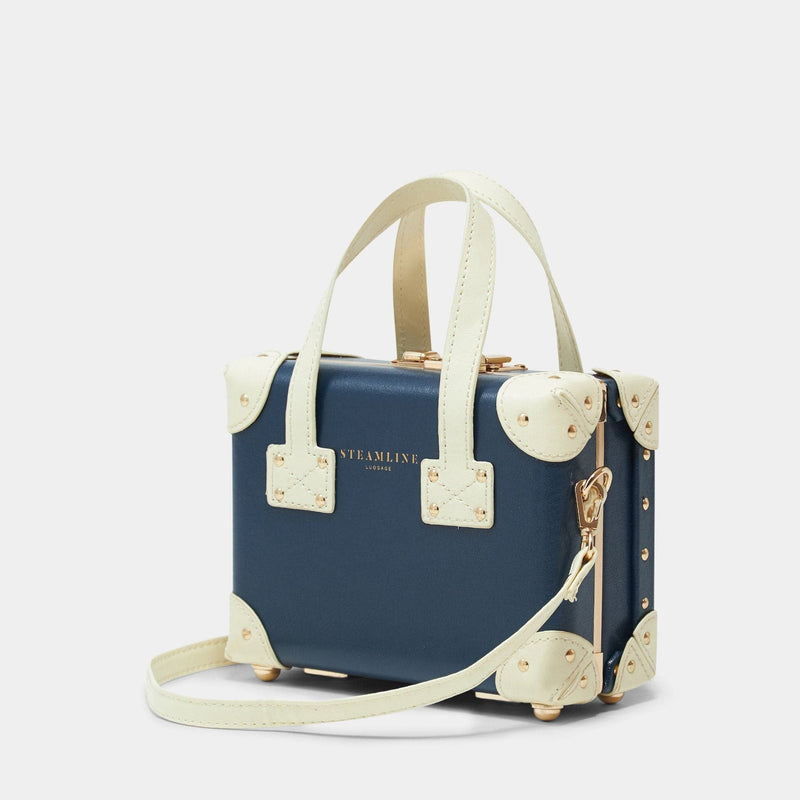 Angled product view of the mini Entrepreneur vegan leather suitcase in navy with shoulder attachment strap