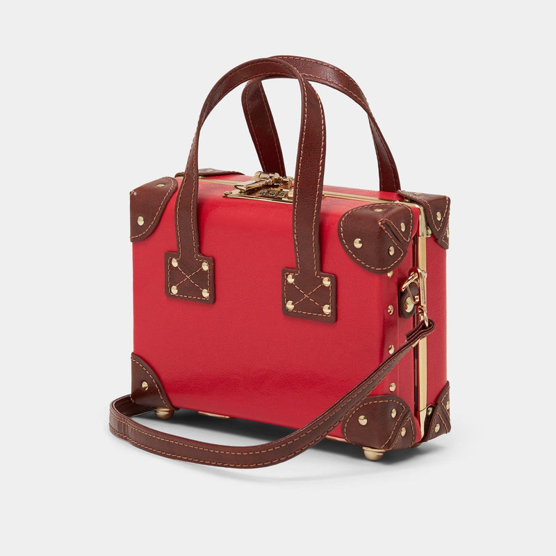 Angled product view of the mini Entrepreneur vegan leather suitcase in red with shoulder attachment strap