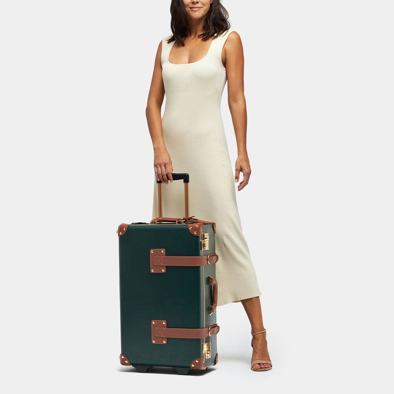 Model with the stowaway Diplomat leather suitcase in hunter green with raised handle