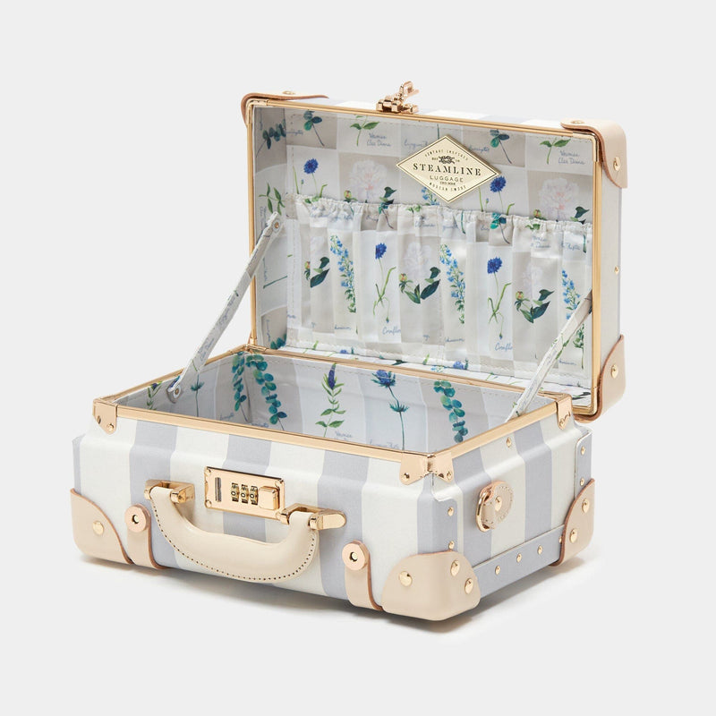 Open product view of the mini Illustrator fibreboard suitcase in blue-stripe with wildflower print lining