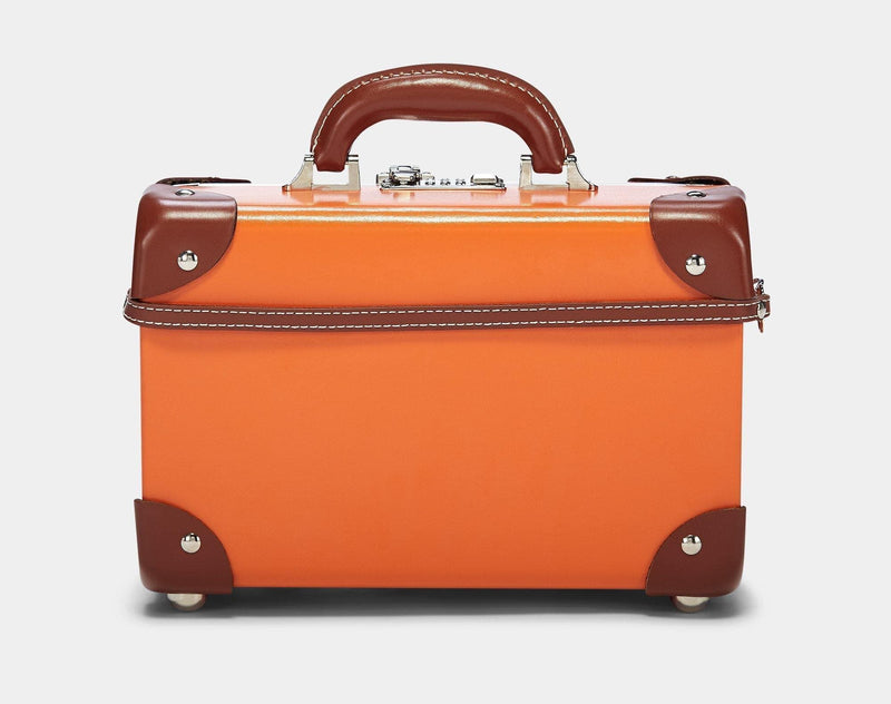 Product view of the vanity Anthropologist leather suitcase in orange with suitcase attachment strap
