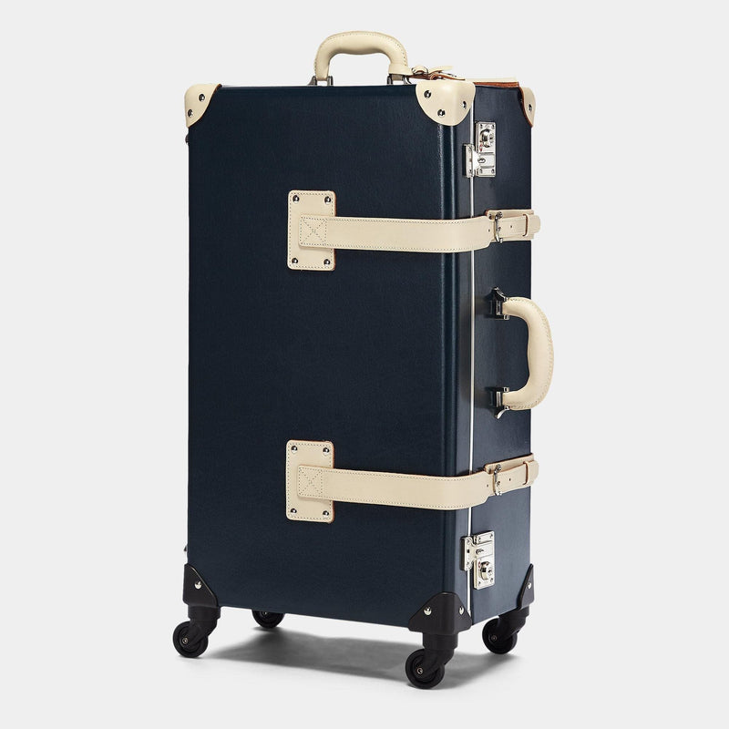 Angled product view of the check-in spinner Anthropologist leather suitcase in navy