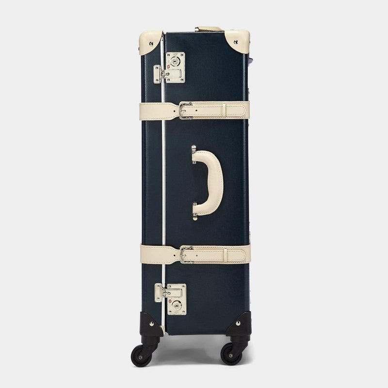 Side product view of the check-in Anthropologist leather suitcase in navy
