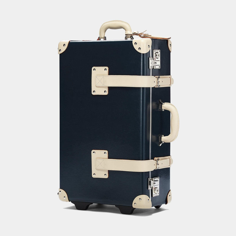 Angled product view of the stowaway Anthropologist leather suitcase in navy
