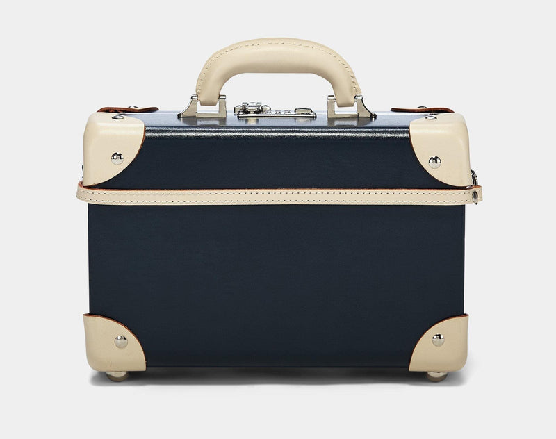 Product view of the vanity Anthropologist leather suitcase in navy with suitcase attachment strap