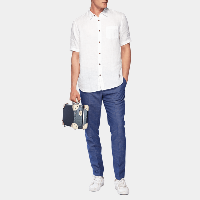 Male model with the vanity Anthropologist leather suitcase in navy