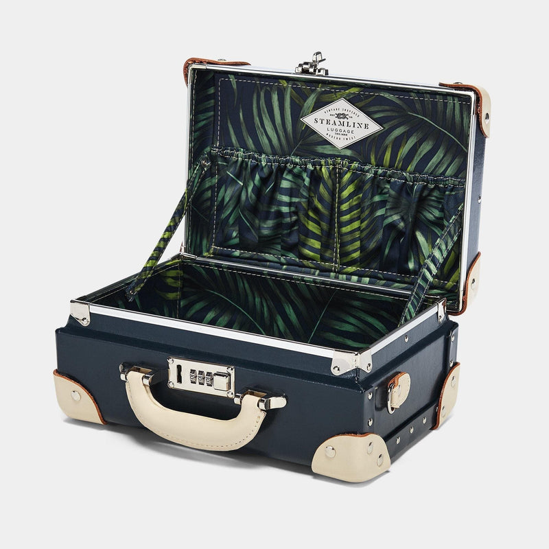 Open product view of the vanity Anthropologist leather suitcase in navy with green palms printed lining