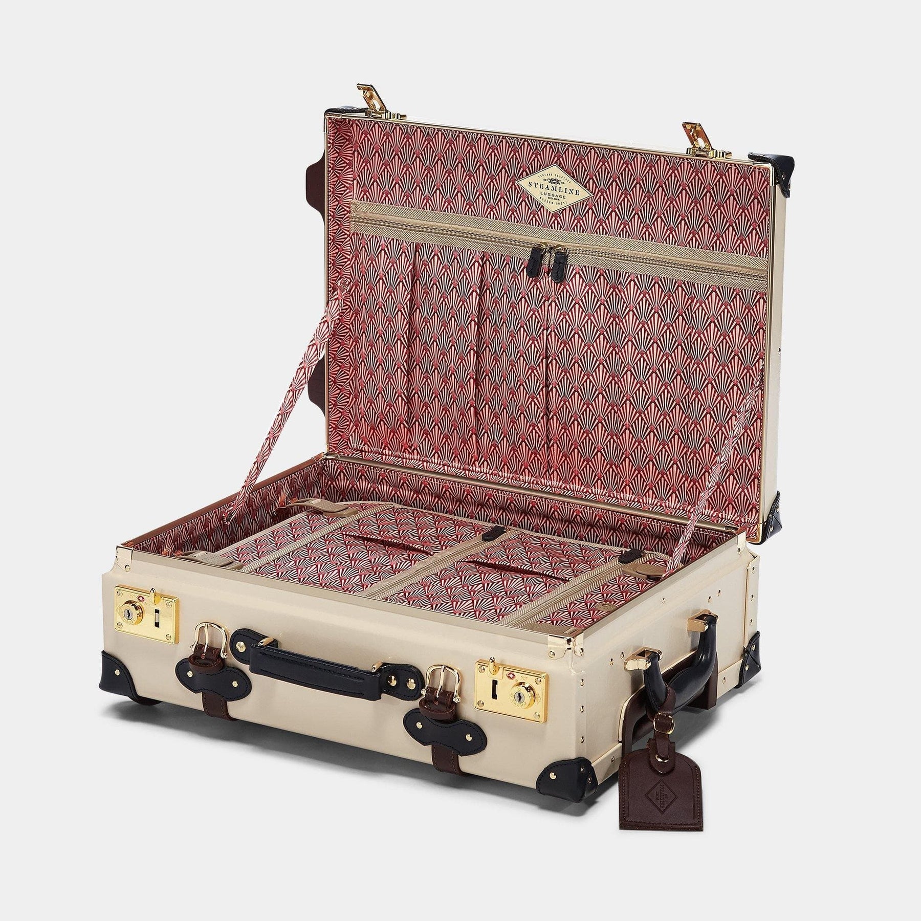 Open product view of the carry-on Architect leather suitcase in cream with art-deco printed lining and brown leather luggage tag