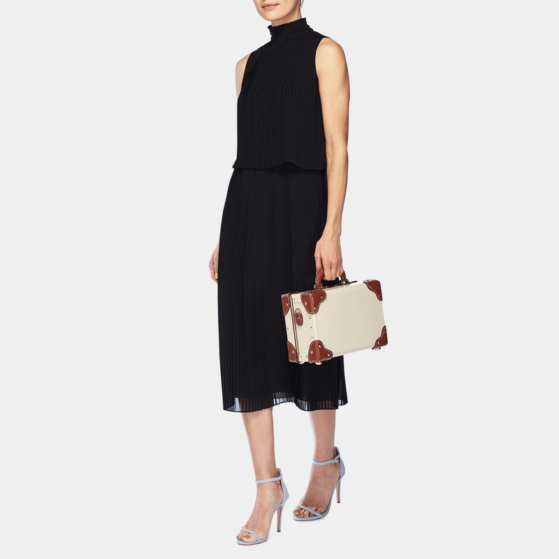 Model with the vanity Diplomat leather suitcase in cream