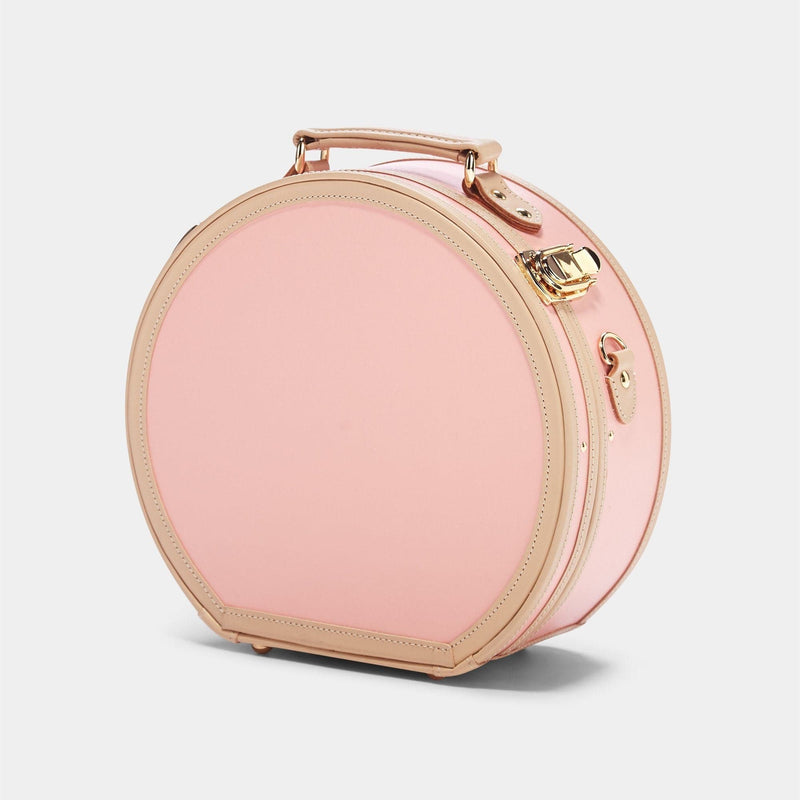 Angled product view of the small hatbox Correspondent fibreboard suitcase in pink